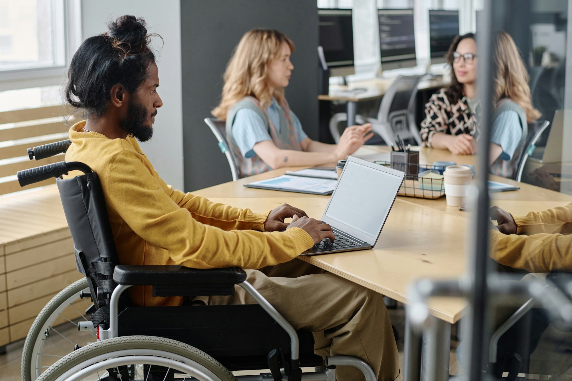 Male Programmer with Disability Working on His Portable Computer in Office