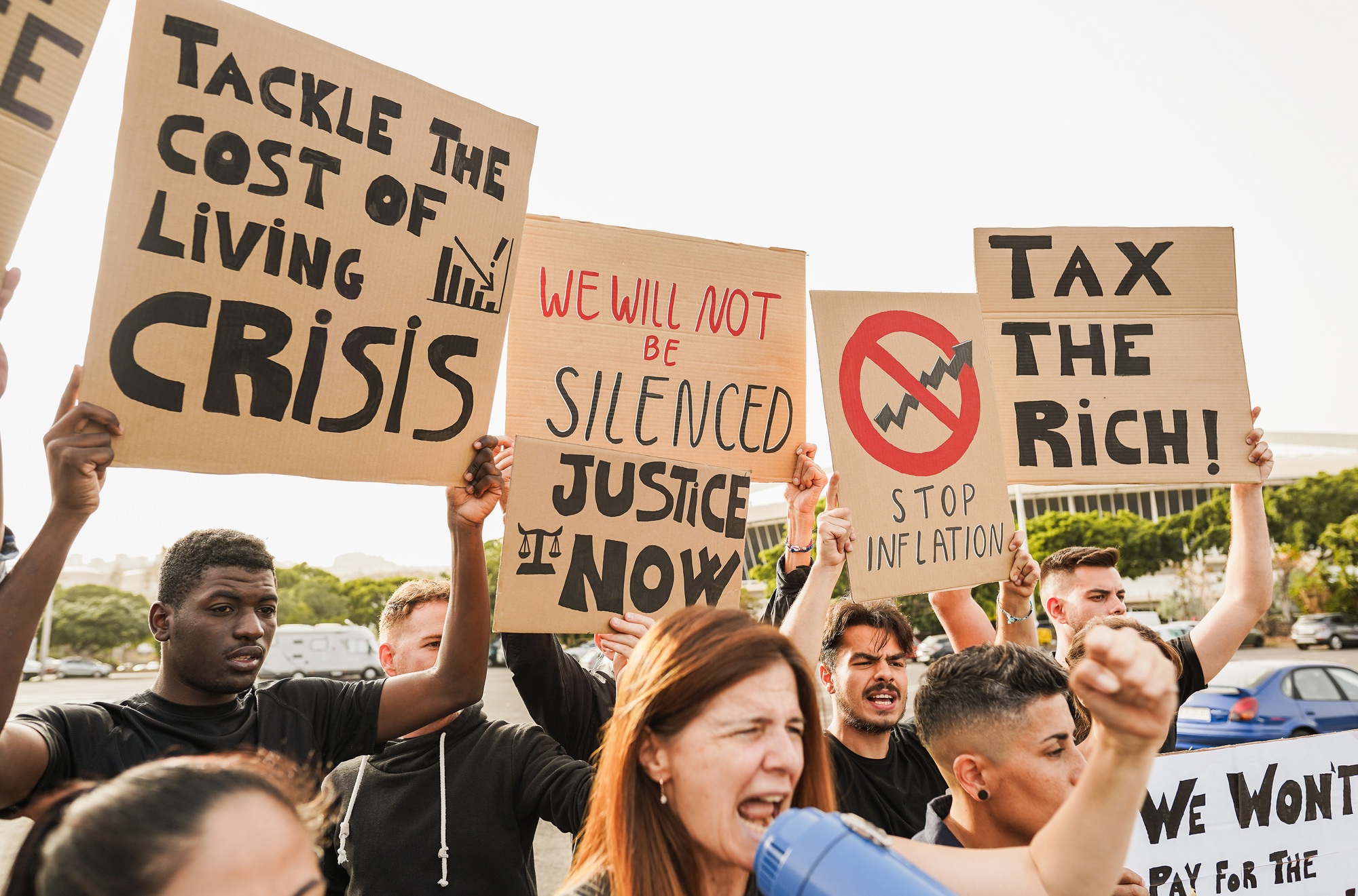 Crowd of multiracial people protest against inflation and financial crisis