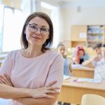 Portrait of middle-aged woman teacher in classroom